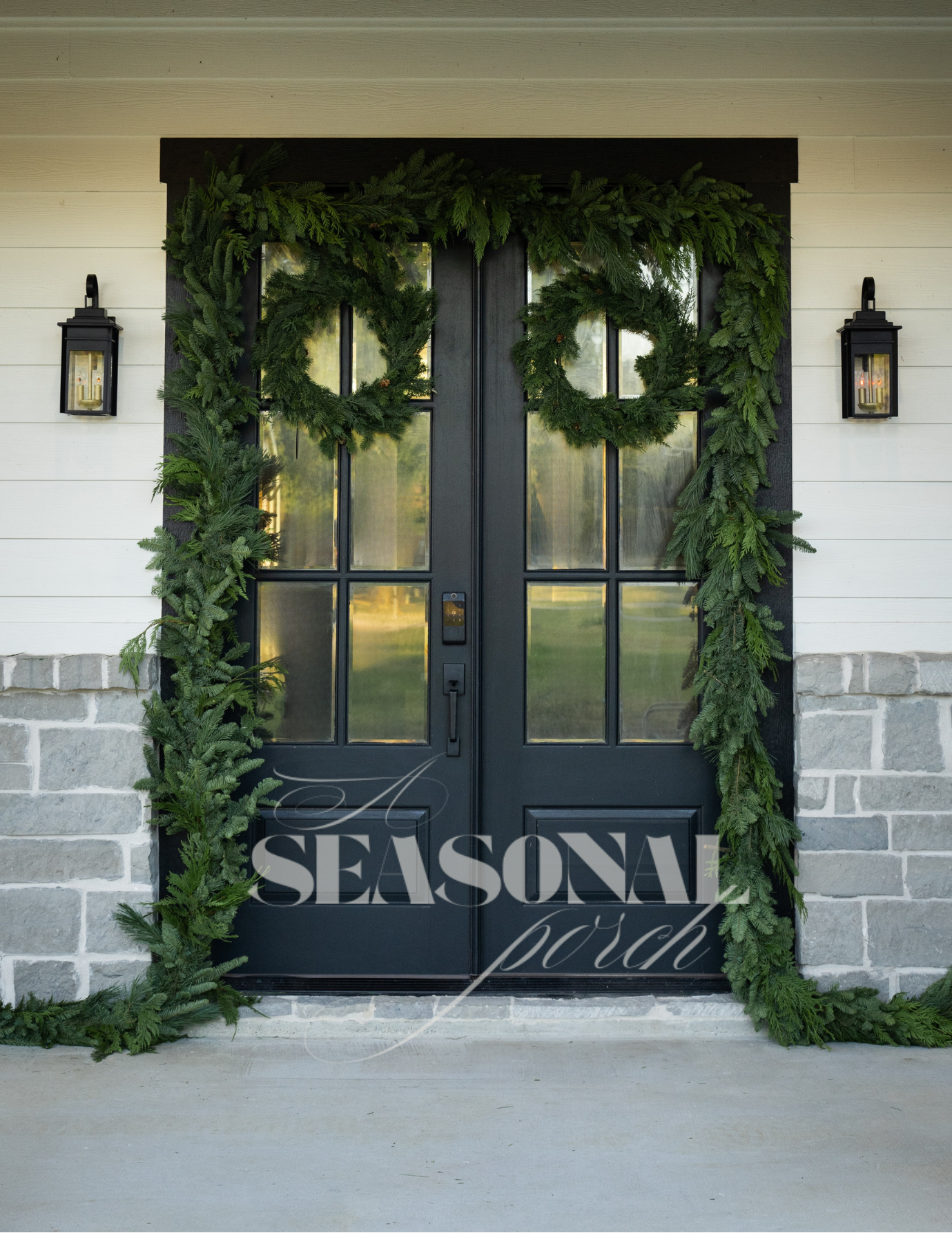 Exterior Black door with holiday Christmas greenery, cedar, fir perfect for winter decor.